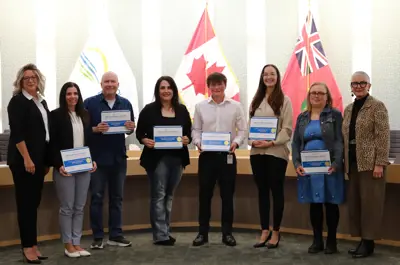 CAO Sandra Zwiers and Warden Hilda MacDonald with those recognized for service at the 2024 Employee Excellence Awards.